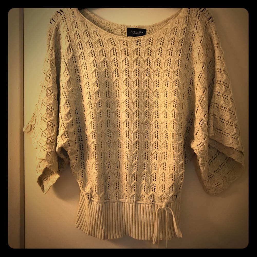 Cream colored sweater with drawstring tie front.