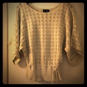 Cream colored sweater with drawstring tie front.