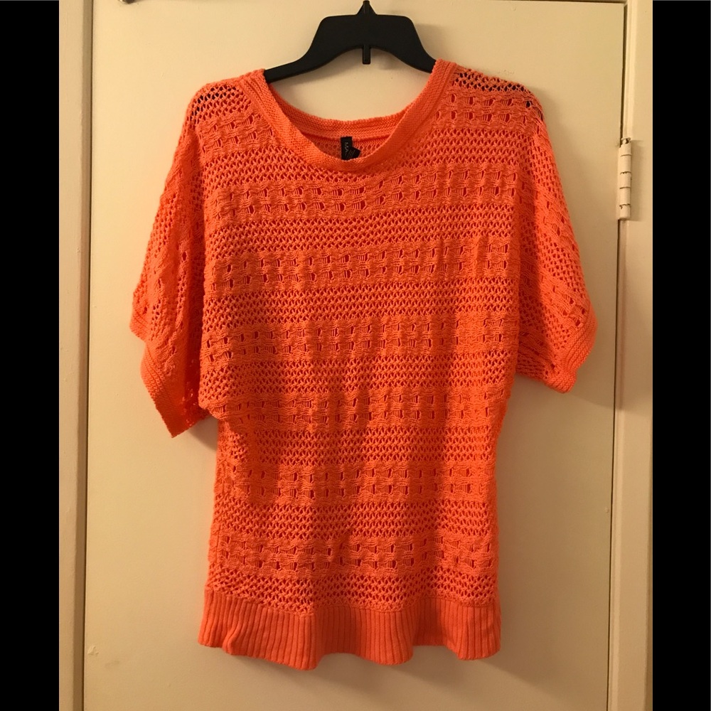 Ladies coral colored sweater.