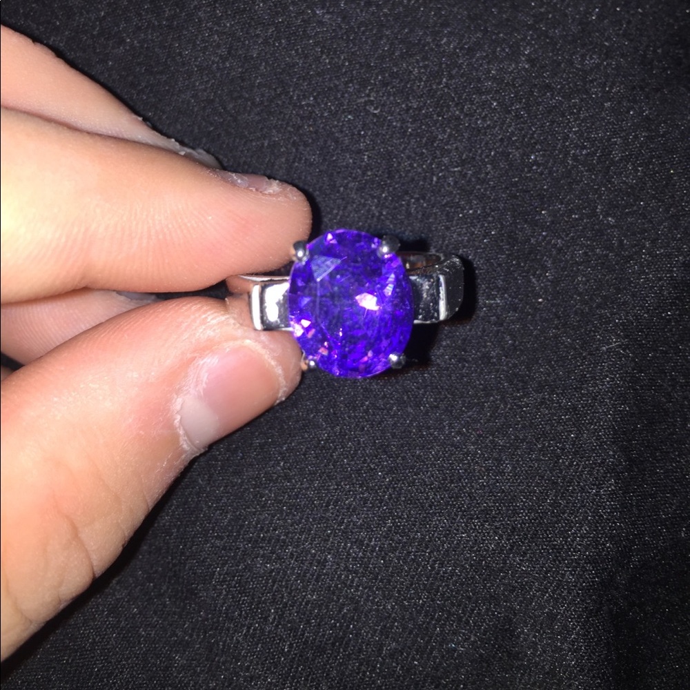Ring with purple stone.
