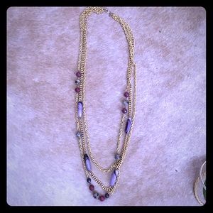 Chain-link necklace with purple beads.