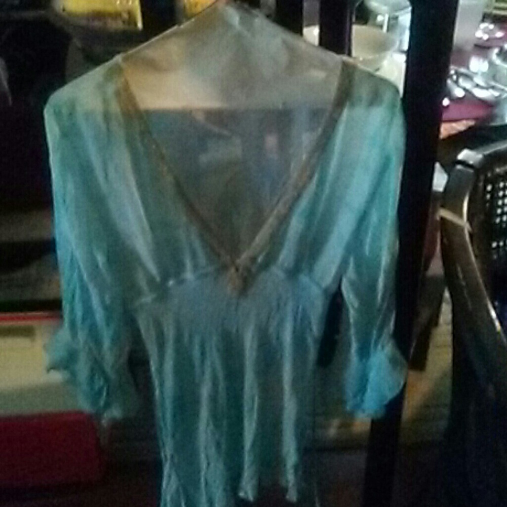 Blouse color is teal