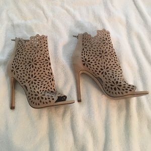 Nude suede high heel booties with laser cut design