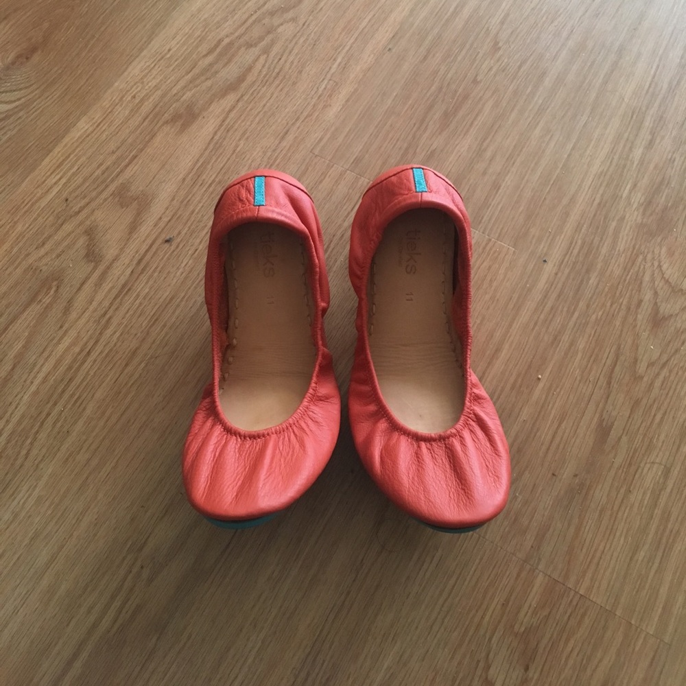 Tangerine colored Tieks size 11.