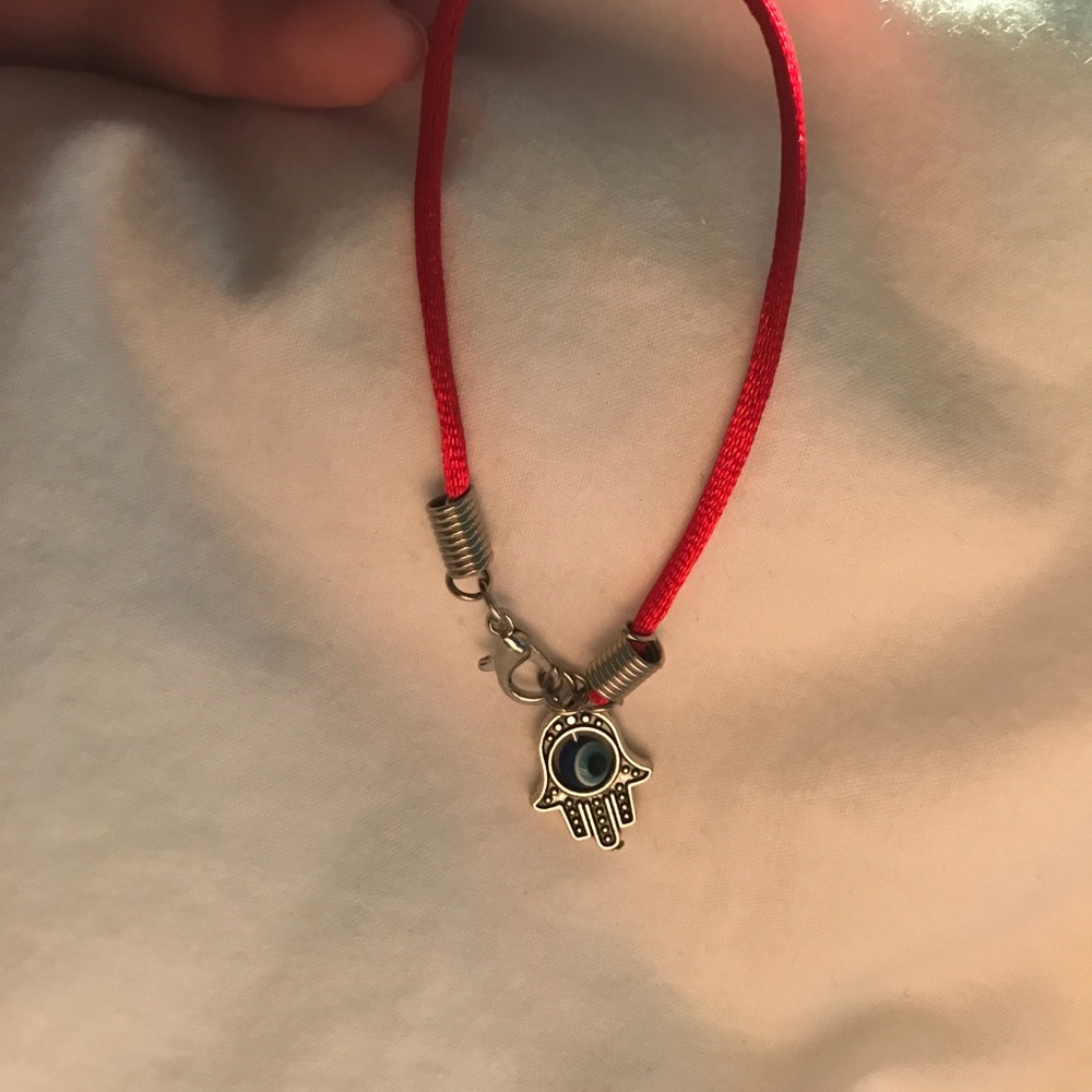 red evil eye/ hand of god