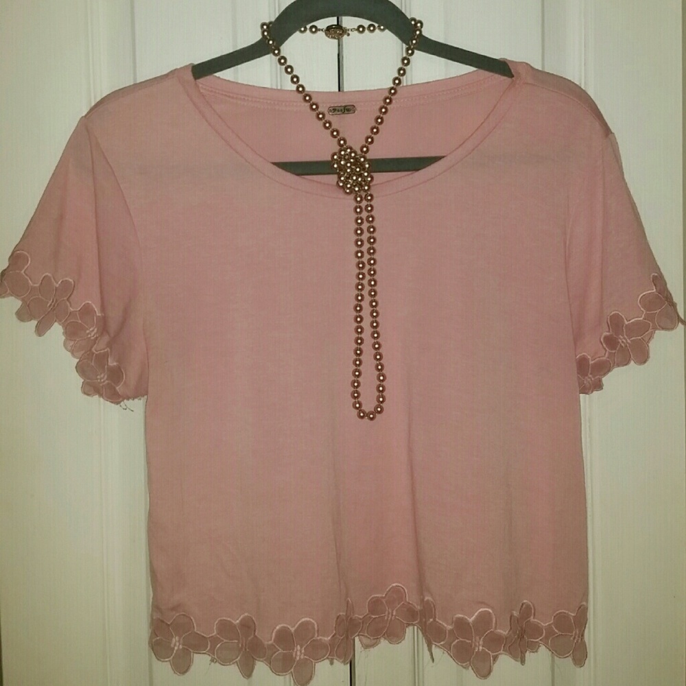 Chic pink blouse with pretty floral accents