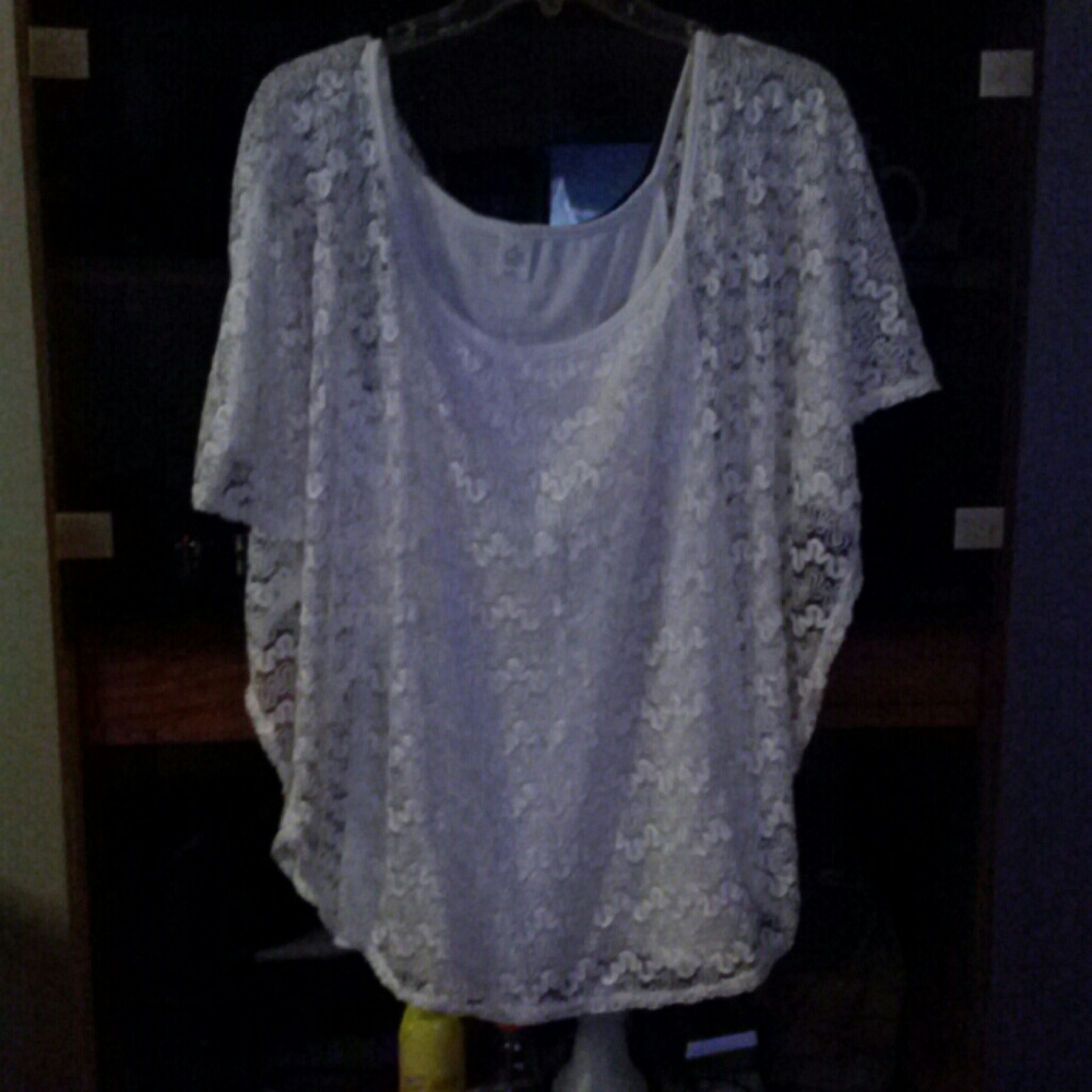 A silky tank top with a covering of outside lace
