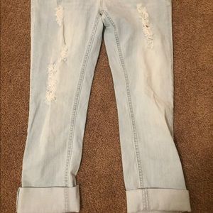 Semi-distressed light wash Capri jeans.