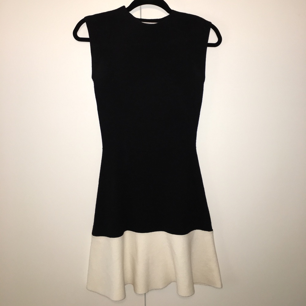 Chic black knit dress with white ruffle-hem