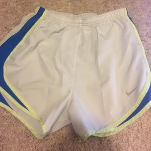 White, blue, and neon yellow Nike tempo shorts