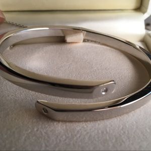 White gold open bangle with two diamond studs