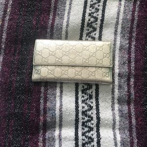 Gucci trifold gold wallet