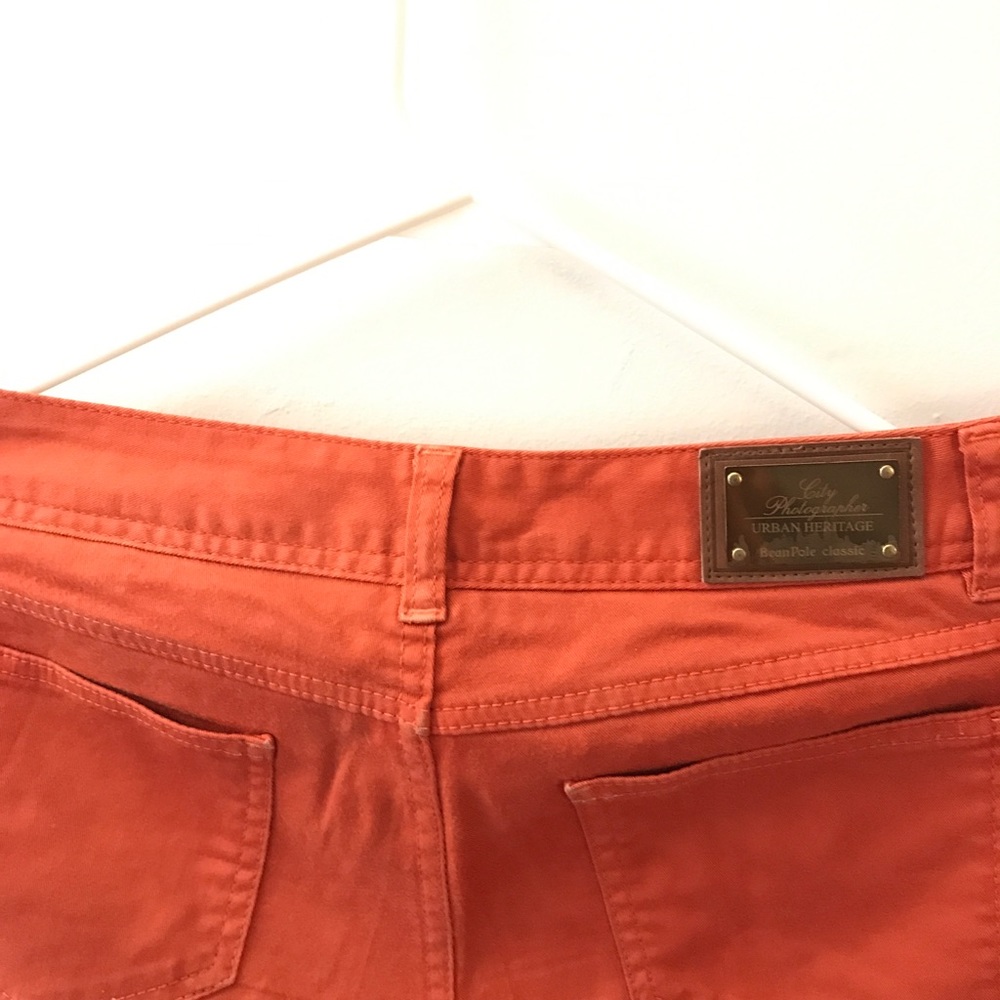 Orange skinny trousers.