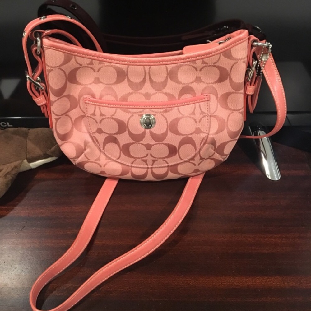 Salmon colored signature C coach bag.