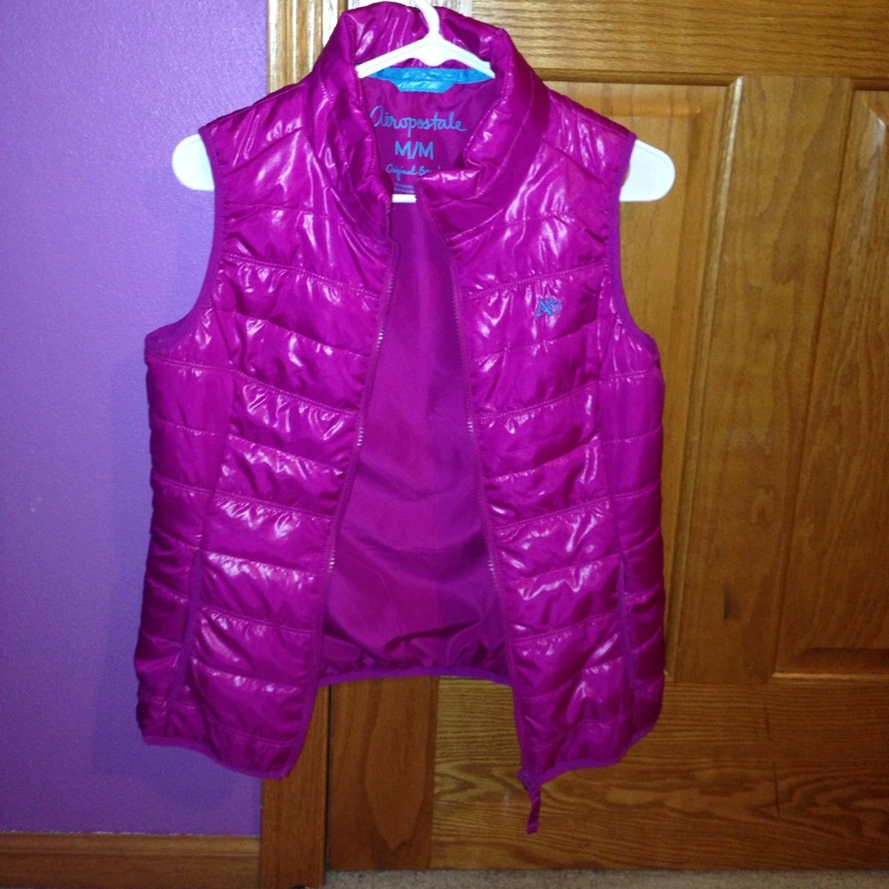 A pink, high neck, vest.
