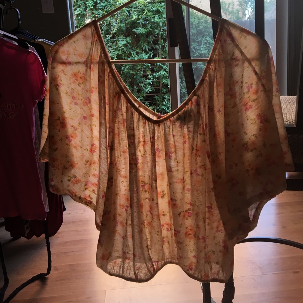 Cream colored shirt, pink and orange flowers.