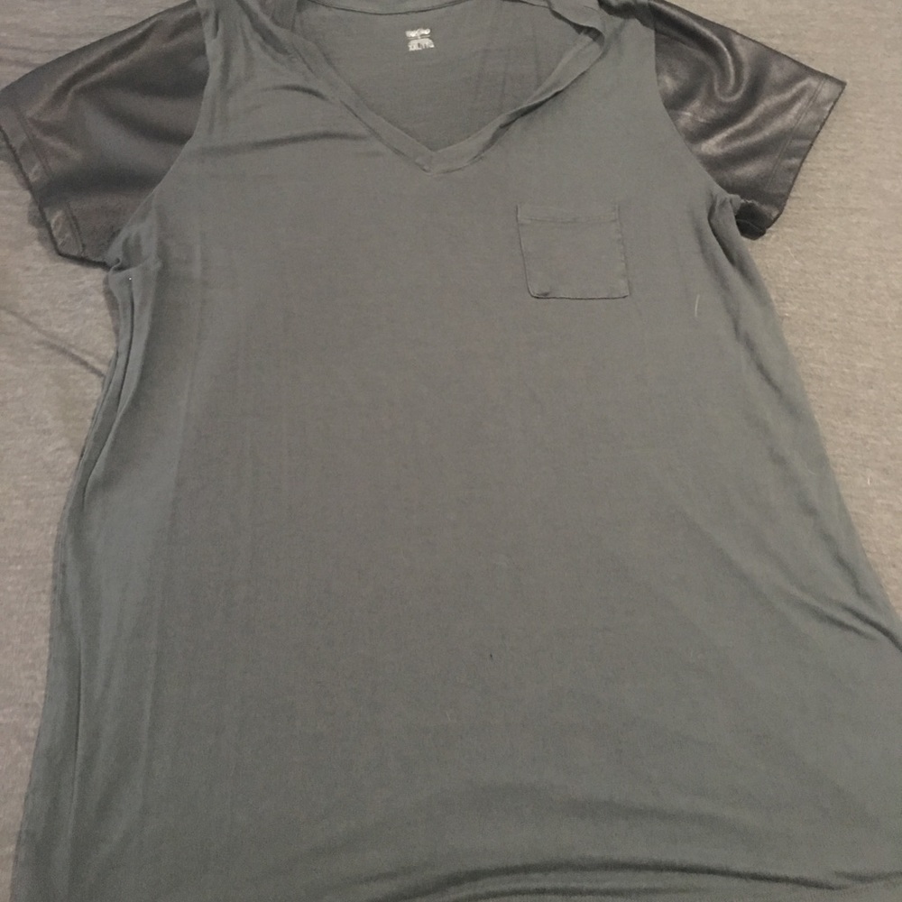 Grey V-neck with faux leather sleeves.