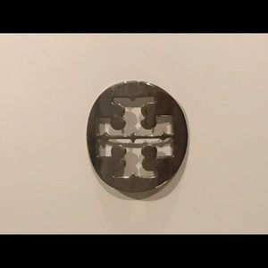 Tory Burch metal logo detail from lucite bracelet