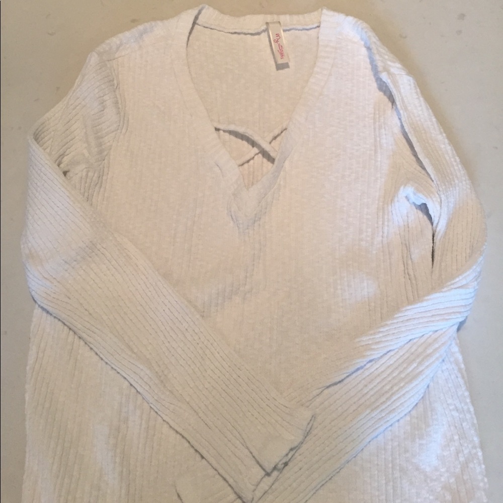 Cute white sweater with cross v-neck front.