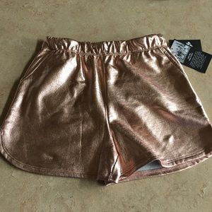 Rose gold pleather shorts.