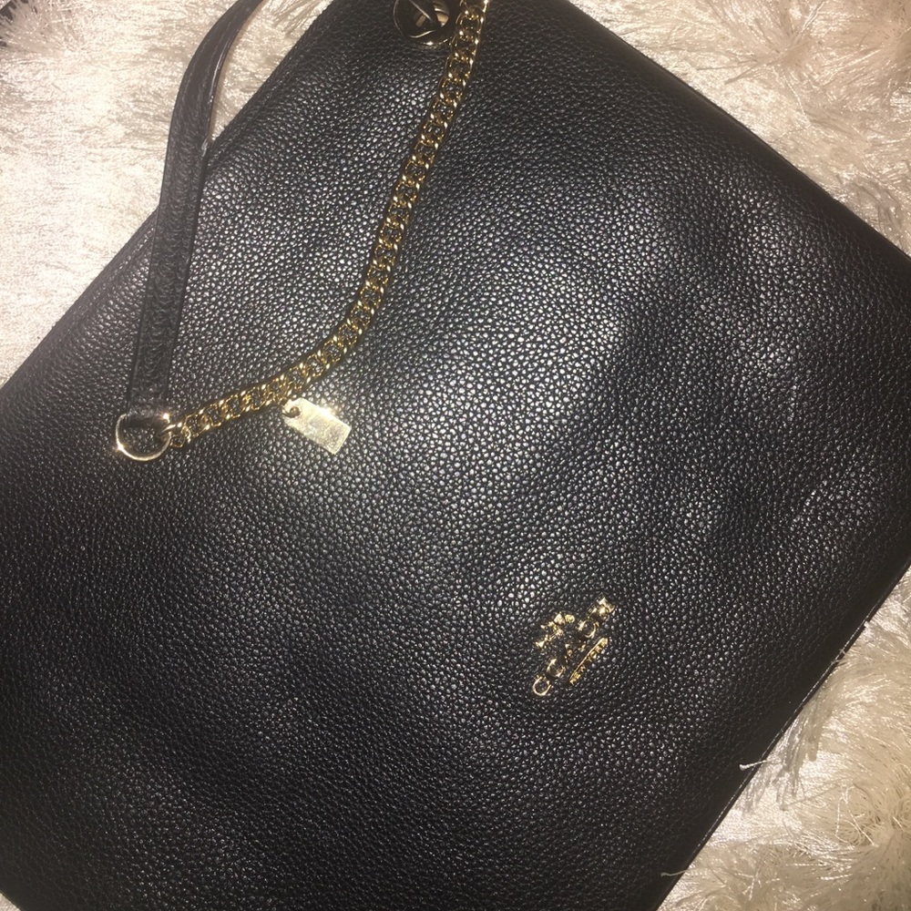 Black Coach Handbag with half gold handle.