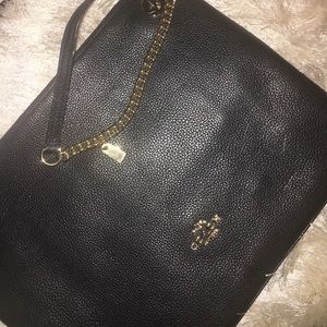 Black Coach Handbag with half gold handle.
