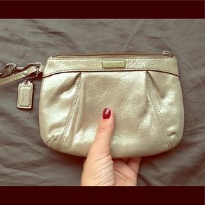 Gold Coach wristlet with pink lining