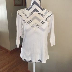 Cream colored top with sheer accents