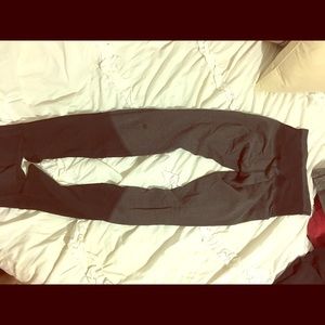 Grey and black Lululemon leggings with foot hole
