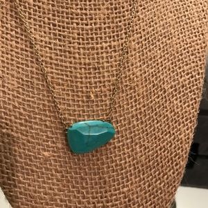 Kendra Scott turquoise necklace with gold chain.