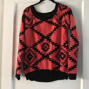 Pink and black sweater.