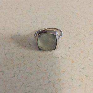 Sterling silver ring with a light green stone.