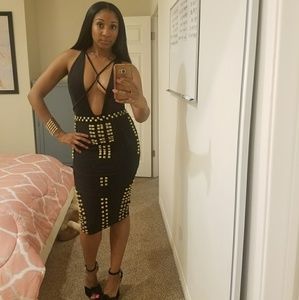 Gold embellished bandage skirt and black bodysuit.