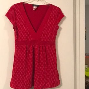 Red V-neck top with small white polka dots