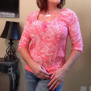 Floral pattern blouse in a coral color.