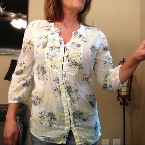 White blouse with floral accents.