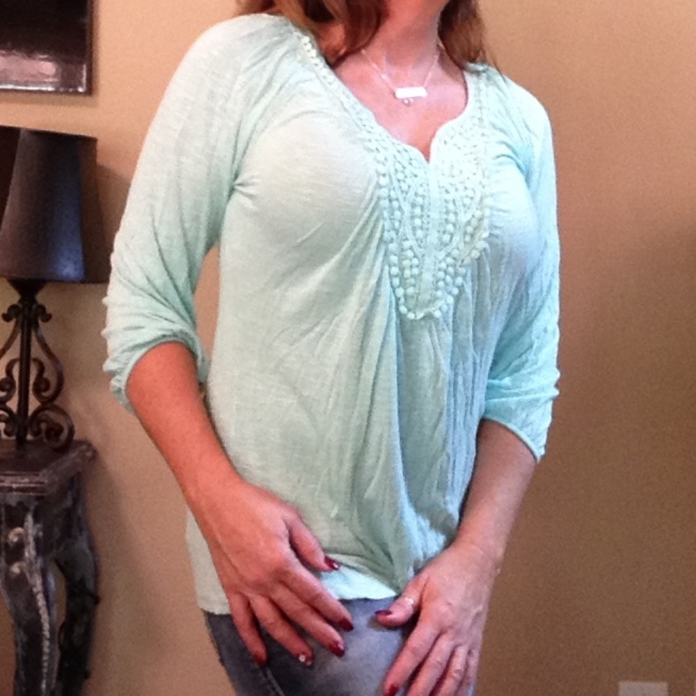 Seafoam green with three-quarter length sleeves.