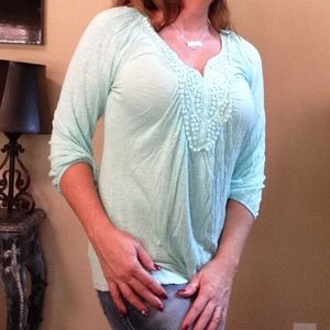 Seafoam green with three-quarter length sleeves.