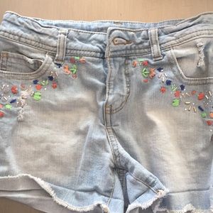 Faded blue shorts with a cute designs