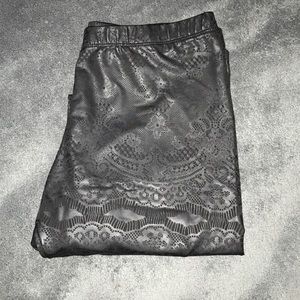 Lace patterned leather leggings