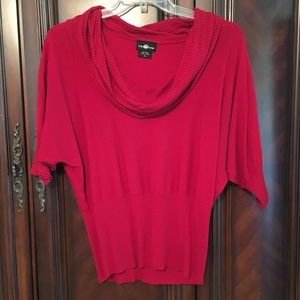 Red sweater with cowl neck.