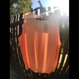 Peach colored sleeveless blouse