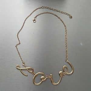 Gold colored "Love" cursive necklace