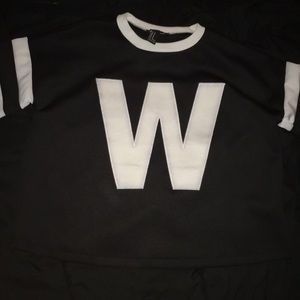 Black top with white neckline and sleeves