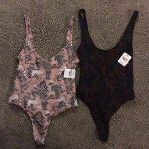 Lot of 2 free people thong style body suites.