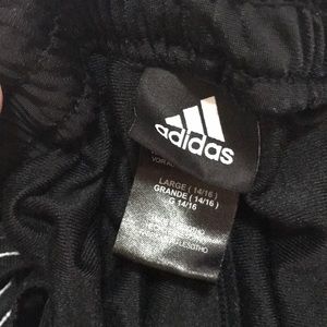 Adidas straight fit black 2 white strip pants.