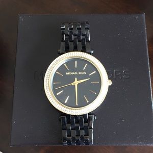 Black and gold Michael Kors watch.