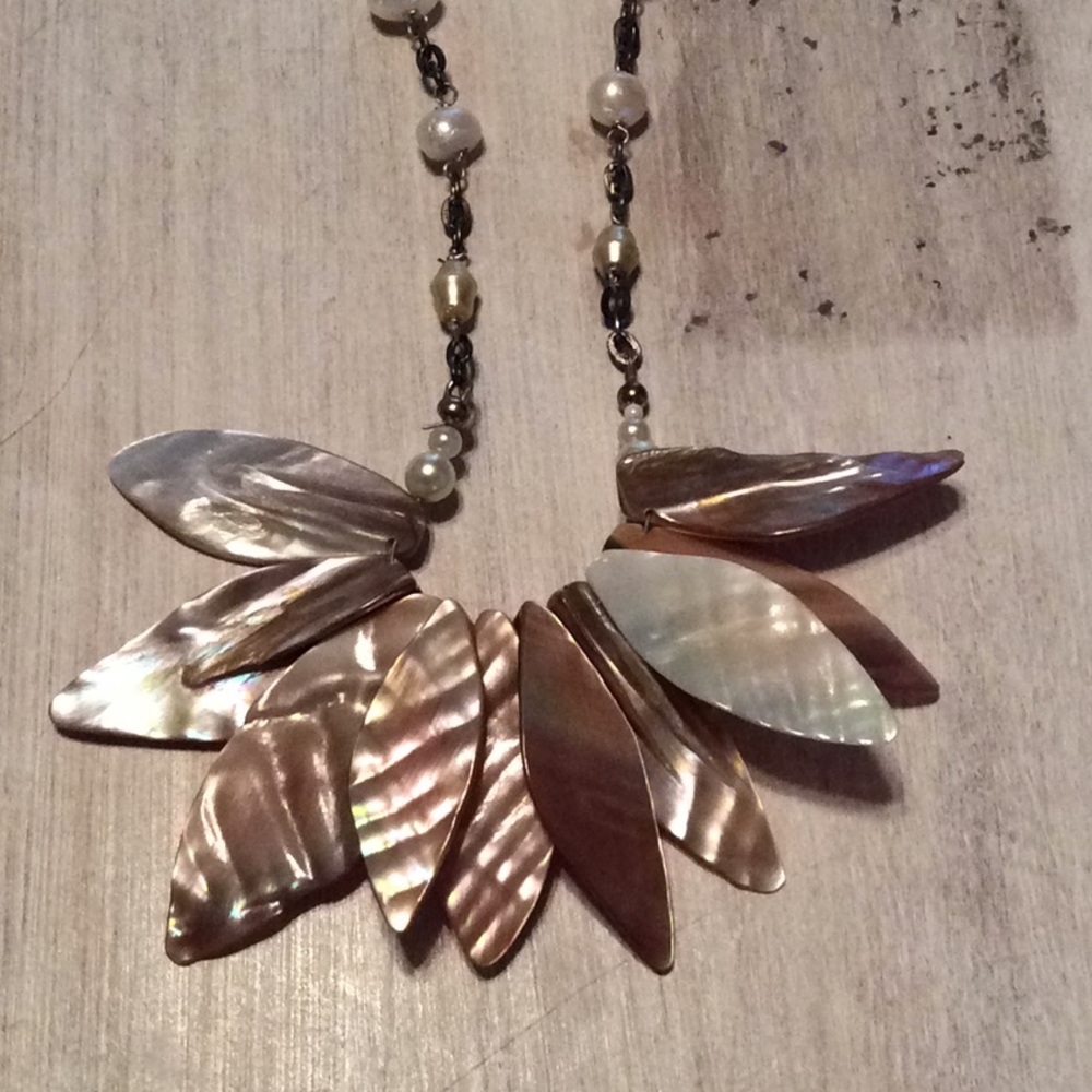 Cream colored faux pearl necklace.