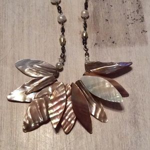 Cream colored faux pearl necklace.