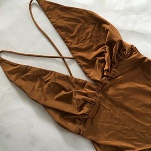 NWT bodysuit. Deep V neck, criss cross back